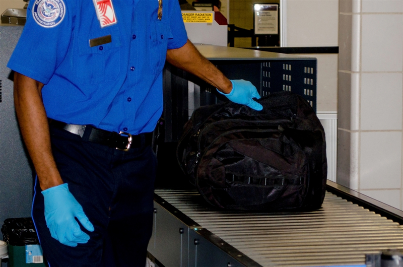 TSA agent examines luggage