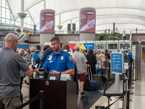 TSA agent questioning a man at the gate