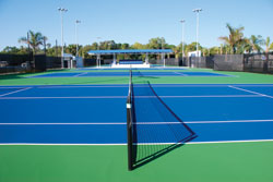 The seating overlooking the courts (visible above the net line) can be used for spectators, team members and personnel, or just for individuals cooling off between games. Photo courtesy of Fast-Dry Courts, Pompano Beach, FL.