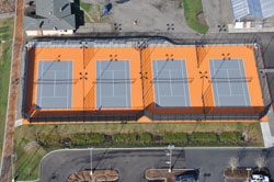 These courts at a local public high school would make an excellent venue for a multi-match event. Note the lighting for night play as well as the divider fencing which will help contain balls to the court on which play is occurring. Photo courtesy of Atlas Track & Tennis, Tualatin, OR.