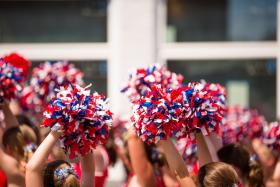Cheerleaders hold pompons in a parade