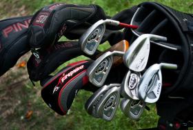 Golf clubs ready for action on a course