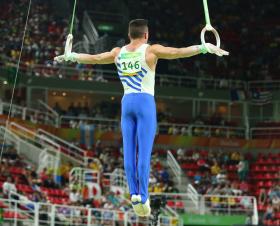 Male gymnast competing in rings