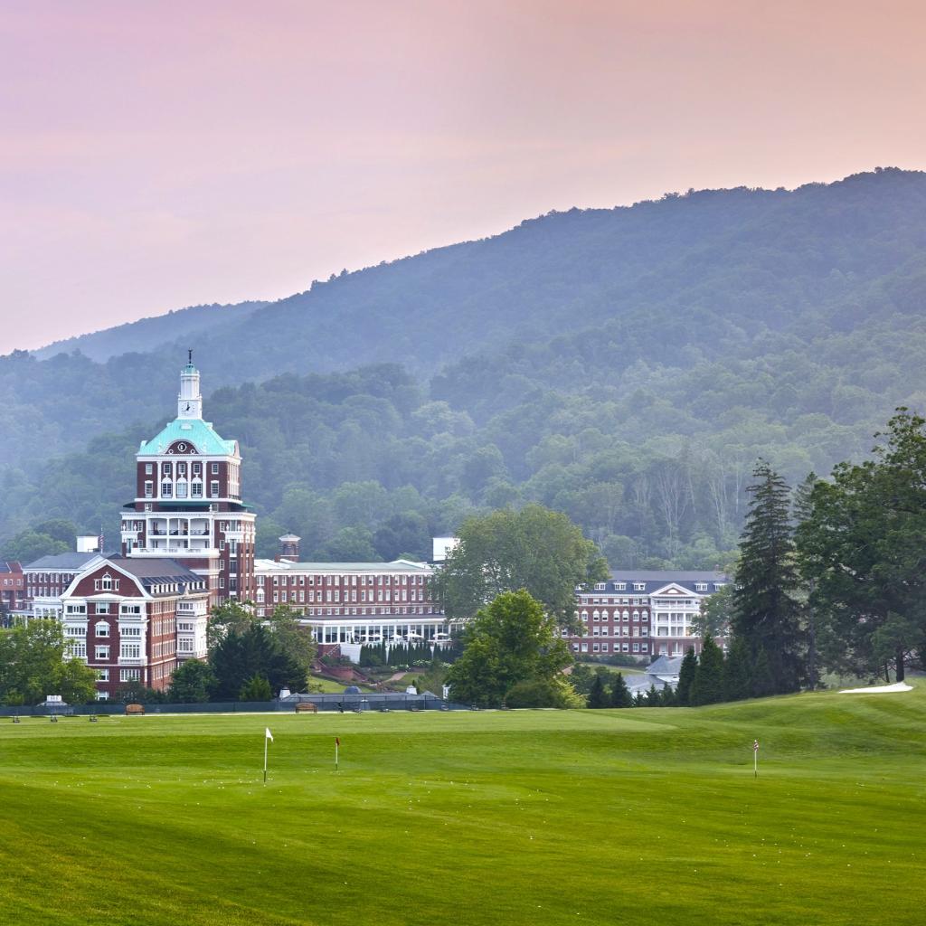 A golf course with a luxury resort in the background