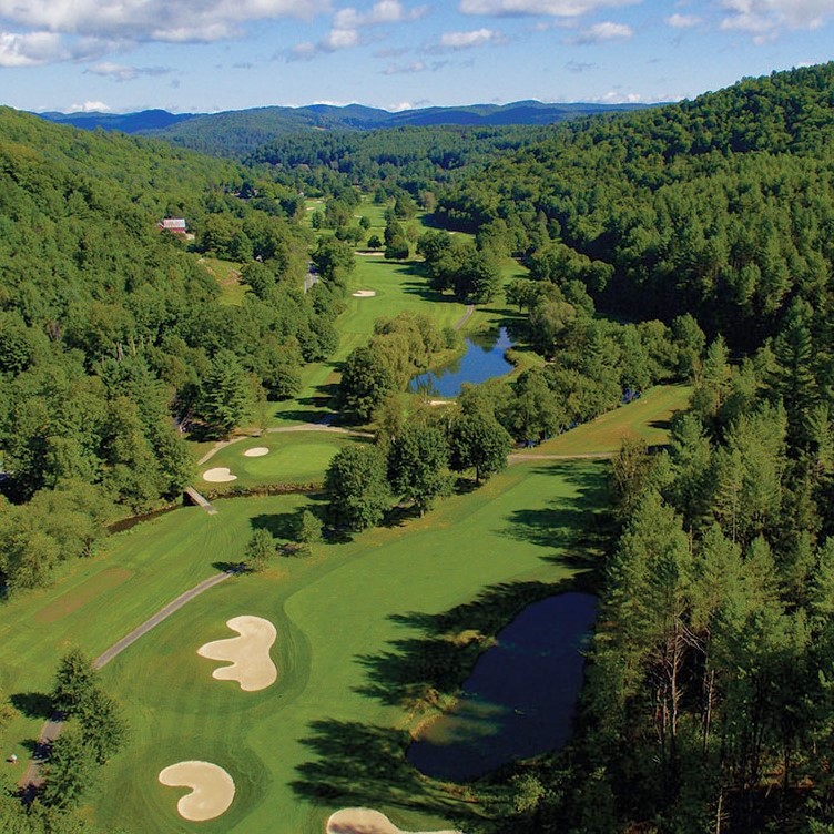 A golf course with a luxury resort in the background
